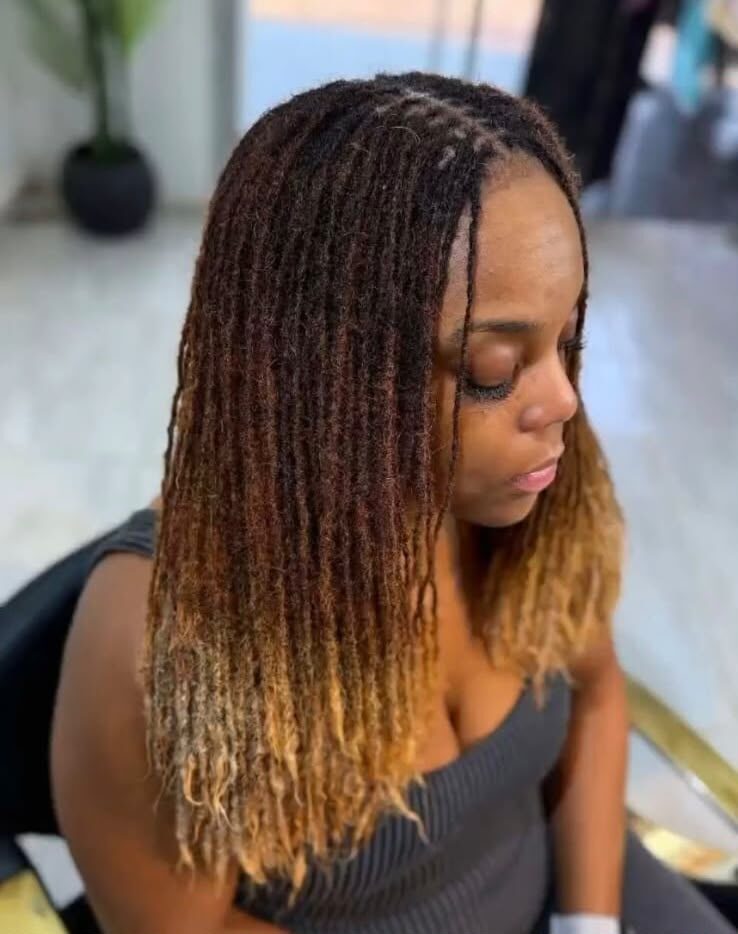 Ombre locs from dark root to honey tip, side profile